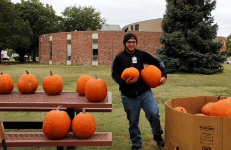 Kyle holding two pumpkins. 